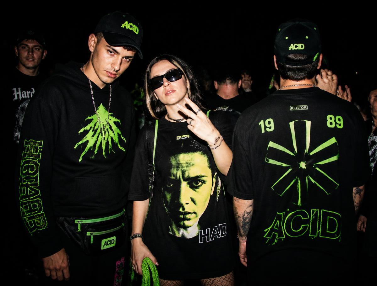 Ravers in black graphic tees, hoodies and caps